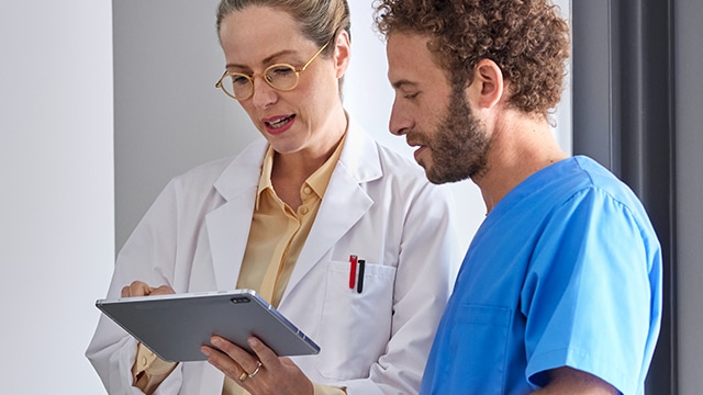 Radiologists and technologist look over tablet